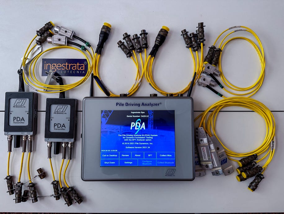 Fotografía muestra equipo de Ingestrata SpA, al centro Data Logger y Computador denominado “Pile Driving Analyzer (PDA)”.  A la izquierda transmisores inalámbricos de señales de los sensores. A la derecha Extensómetros.  Acelerómetros en parte superior,